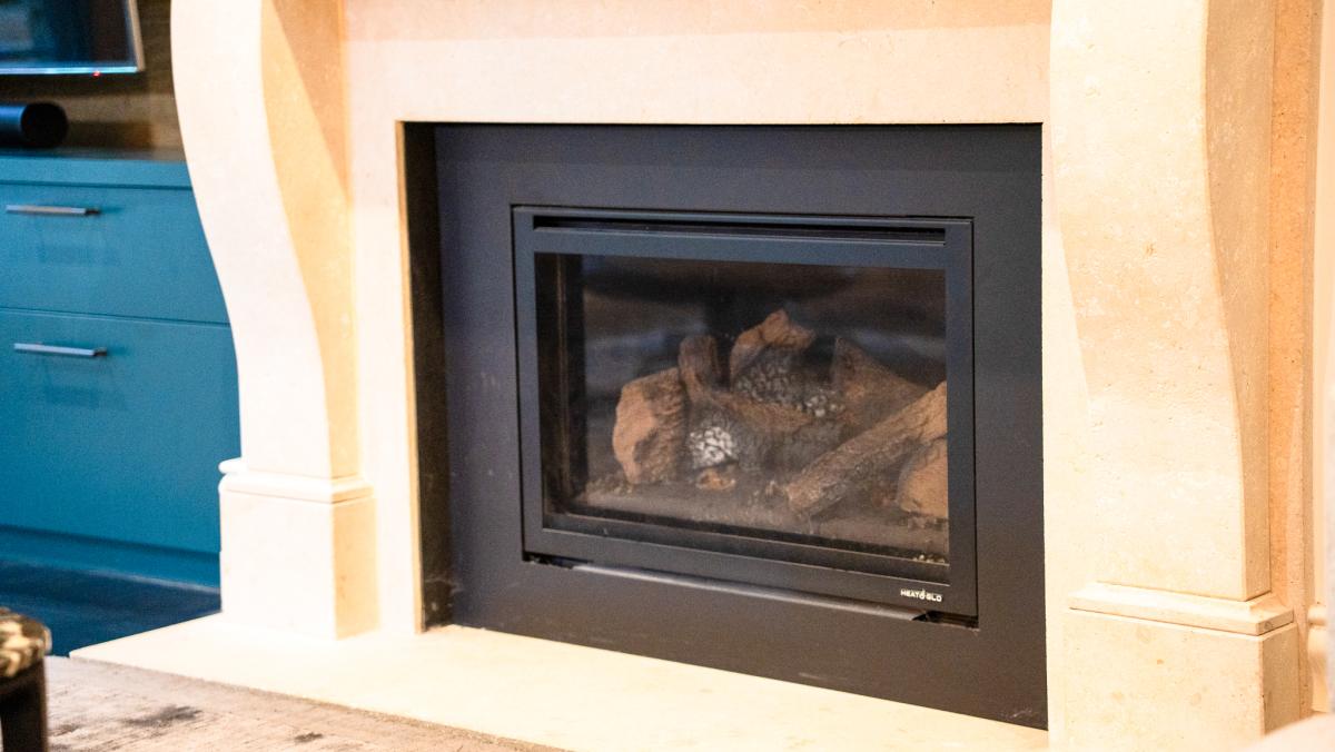 Modern built-in fireplace with black frame and decorative logs in renovated Melbourne home interior